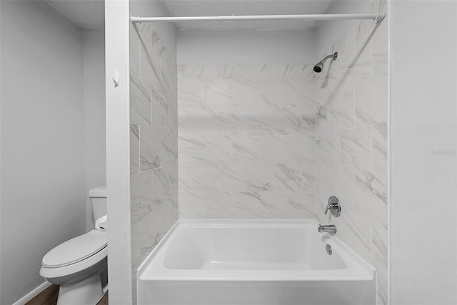 bathroom featuring toilet, tiled shower / bath combo, and hardwood / wood-style flooring