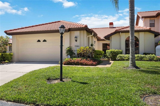 mediterranean / spanish-style house featuring a front lawn and a garage