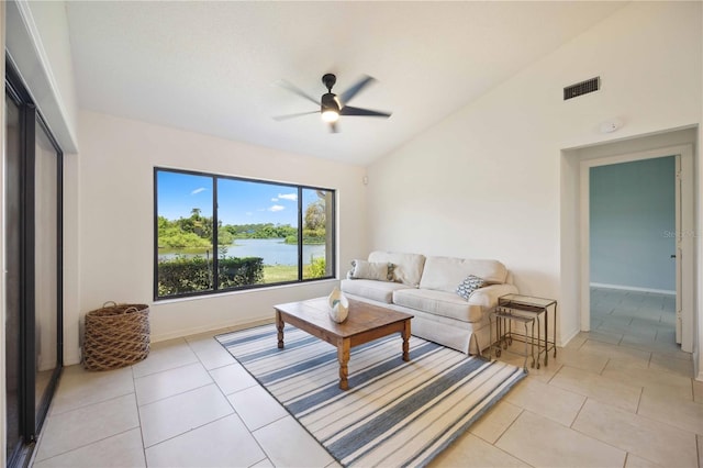 tiled living room featuring ceiling fan and lofted ceiling