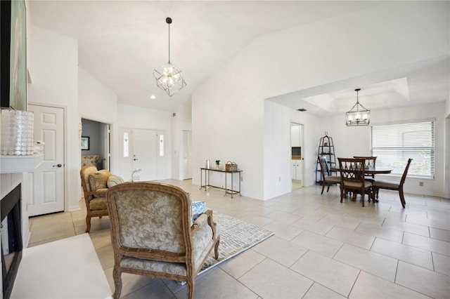 tiled living room featuring an inviting chandelier and vaulted ceiling