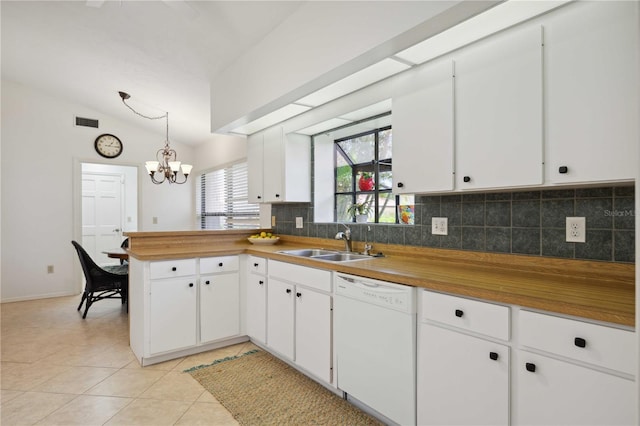 kitchen featuring vaulted ceiling, hanging light fixtures, white dishwasher, white cabinets, and sink