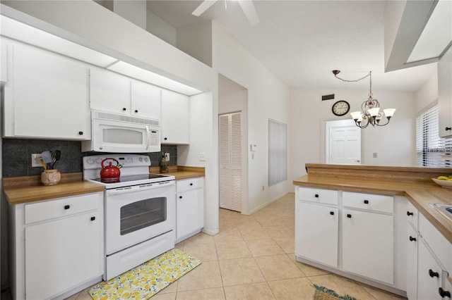 kitchen featuring wooden counters, white cabinetry, white appliances, and hanging light fixtures