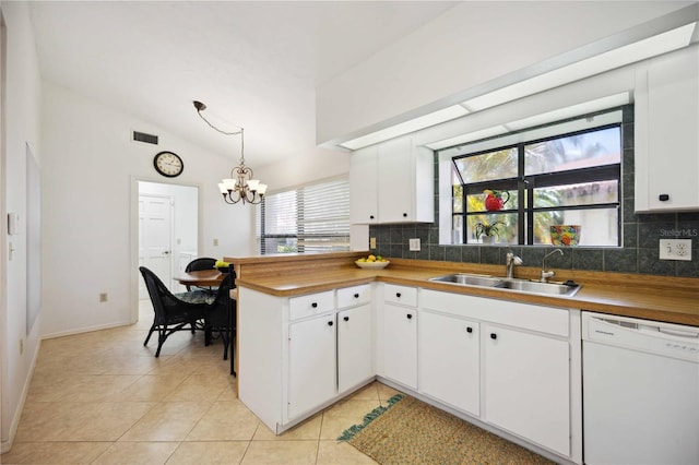 kitchen featuring hanging light fixtures, white dishwasher, butcher block countertops, sink, and white cabinetry