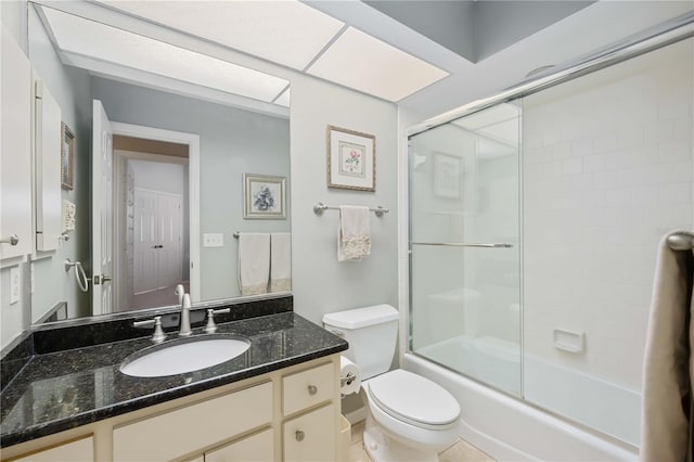 full bathroom with toilet, vanity, and shower / bath combination with glass door