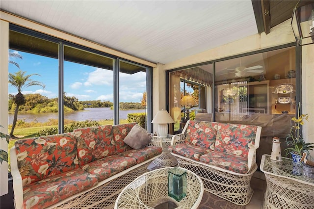 sunroom featuring a water view