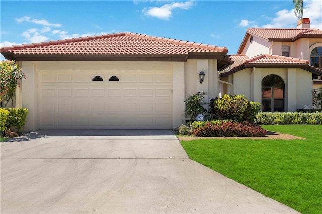 mediterranean / spanish-style house with a garage and a front yard