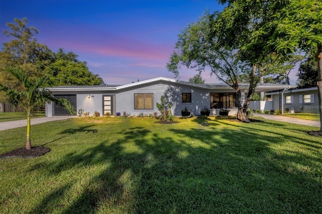 view of front facade with a yard and a garage