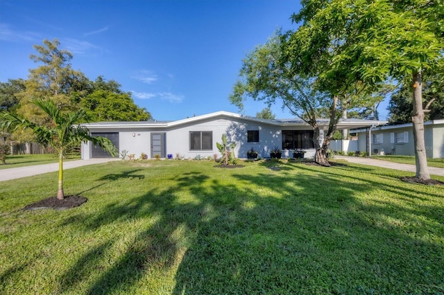 ranch-style home featuring a front yard and a garage