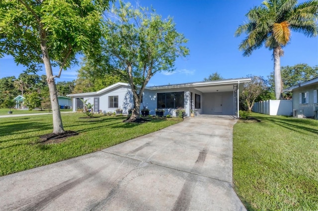 ranch-style house with a carport and a front lawn