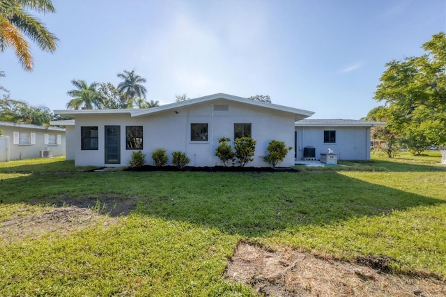 rear view of house featuring a lawn