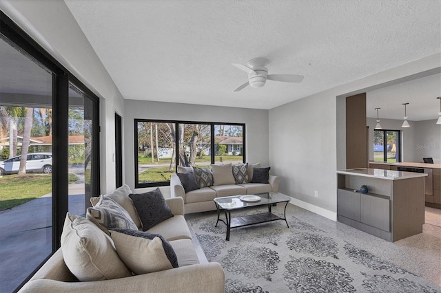 living room featuring a textured ceiling and ceiling fan