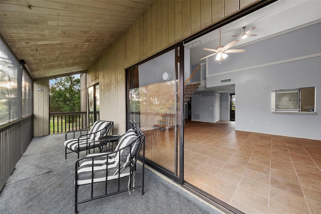 sunroom / solarium featuring ceiling fan