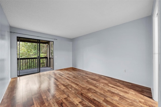 empty room featuring light hardwood / wood-style floors and a textured ceiling