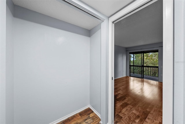 hallway with hardwood / wood-style floors