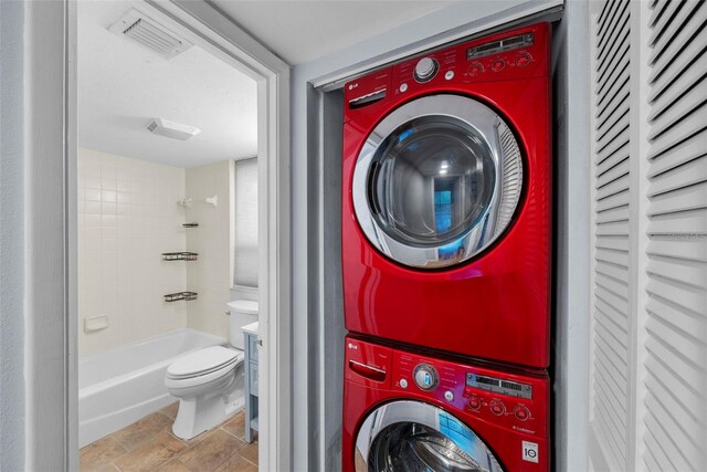 washroom featuring stacked washer / dryer