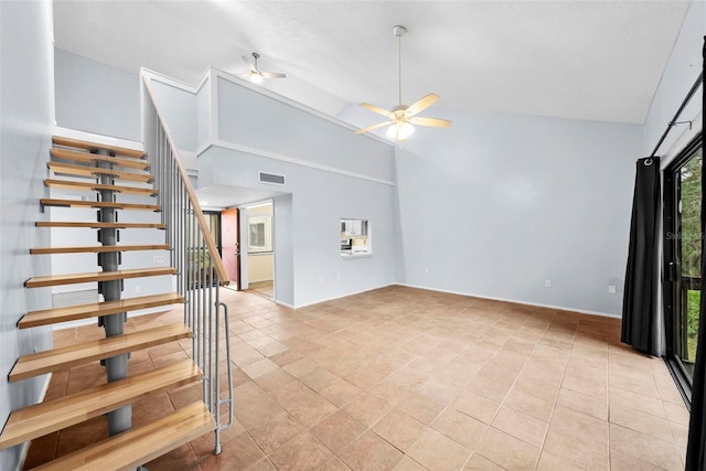 interior space with ceiling fan, light tile patterned floors, and high vaulted ceiling