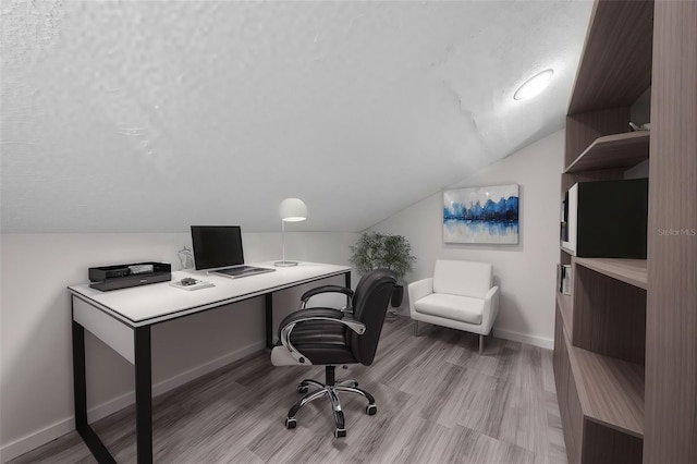 office with light hardwood / wood-style flooring and vaulted ceiling