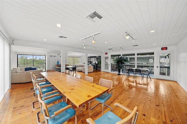 dining room with light hardwood / wood-style flooring, rail lighting, and wooden ceiling