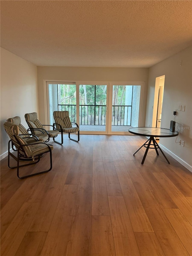 interior space featuring a textured ceiling and hardwood / wood-style floors