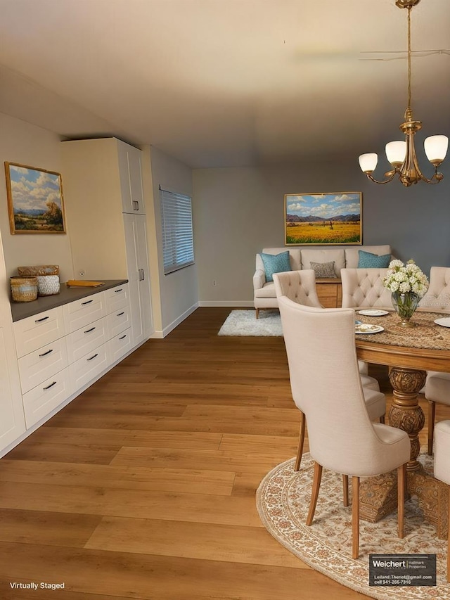 dining room with a notable chandelier and light hardwood / wood-style flooring