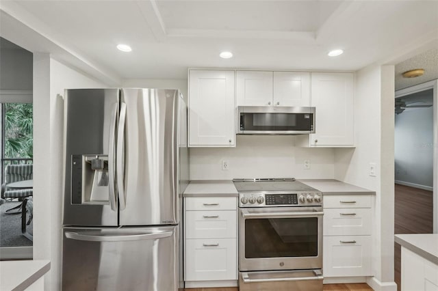 2753 Orchid Oaks Dr Unit 104, Sarasota, FL 34239 - kitchen featuring appliances with stainless steel finishes, recessed lighting, white cabinets, light countertops, and light wood finished floors