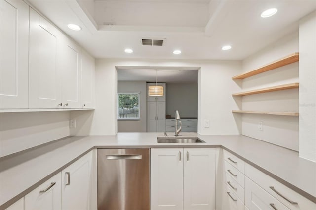 2753 Orchid Oaks Dr Unit 104, Sarasota, FL 34239 - kitchen featuring stainless steel dishwasher, a sink, recessed lighting, light countertops, and white cabinetry