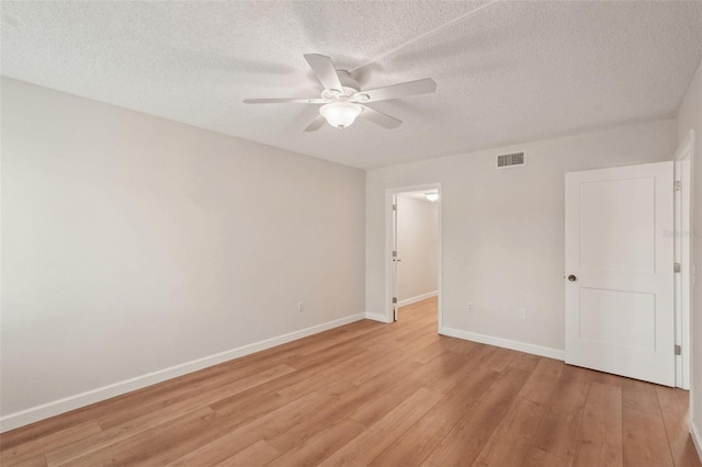 2753 Orchid Oaks Dr Unit 104, Sarasota, FL 34239 - empty room featuring ceiling fan, light wood finished floors, baseboards, and a textured ceiling