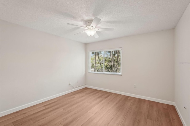 2753 Orchid Oaks Dr Unit 104, Sarasota, FL 34239 - unfurnished room with light wood-type flooring, ceiling fan, baseboards, and a textured ceiling