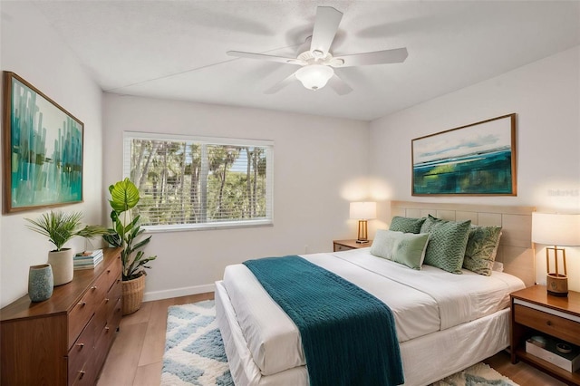 2753 Orchid Oaks Dr Unit 104, Sarasota, FL 34239 - bedroom featuring light wood-style floors, baseboards, and a ceiling fan