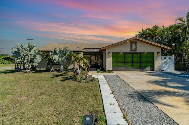 view of front facade featuring a lawn and a garage