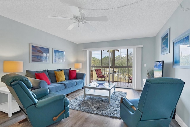 living room featuring hardwood / wood-style floors, a textured ceiling, and ceiling fan