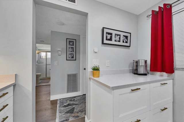 interior space featuring a textured ceiling, vanity, and toilet