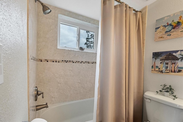 bathroom featuring toilet and shower / bath combo with shower curtain