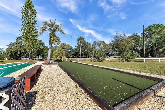 view of property's community featuring a yard