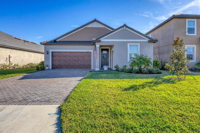 view of front of property with a front lawn and a garage