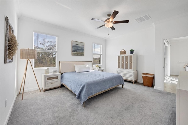 carpeted bedroom featuring ceiling fan and ornamental molding