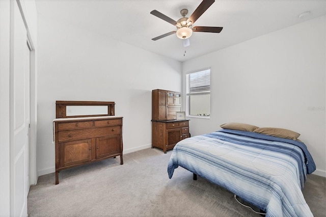 carpeted bedroom with a closet and ceiling fan