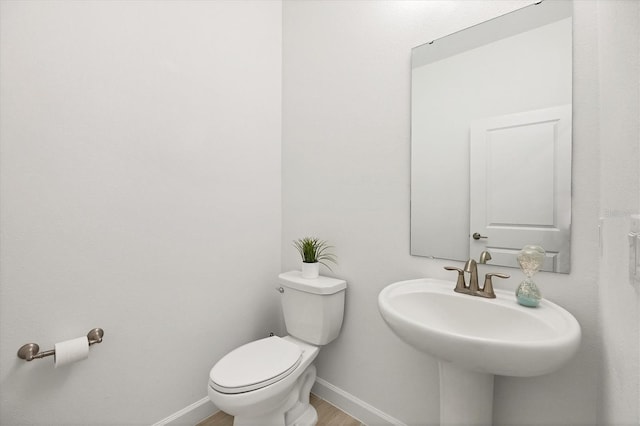 bathroom featuring sink and toilet