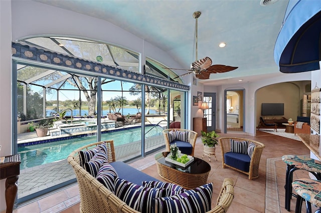 sunroom / solarium with ceiling fan, a pool, and lofted ceiling