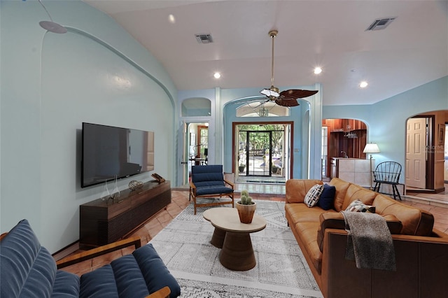 tiled living room with lofted ceiling and ceiling fan