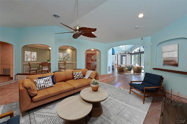 tiled living room featuring vaulted ceiling and ceiling fan