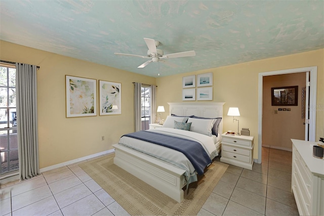 tiled bedroom featuring a textured ceiling and ceiling fan