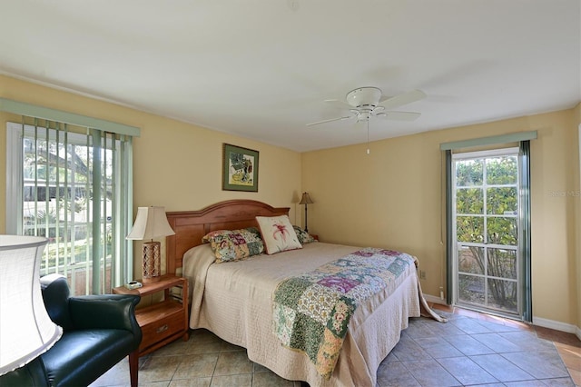 tiled bedroom featuring ceiling fan and multiple windows