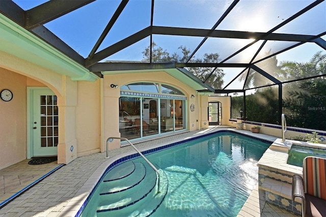 view of swimming pool with glass enclosure and a patio area