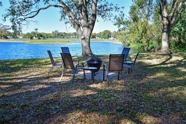 view of yard with a fire pit and a water view