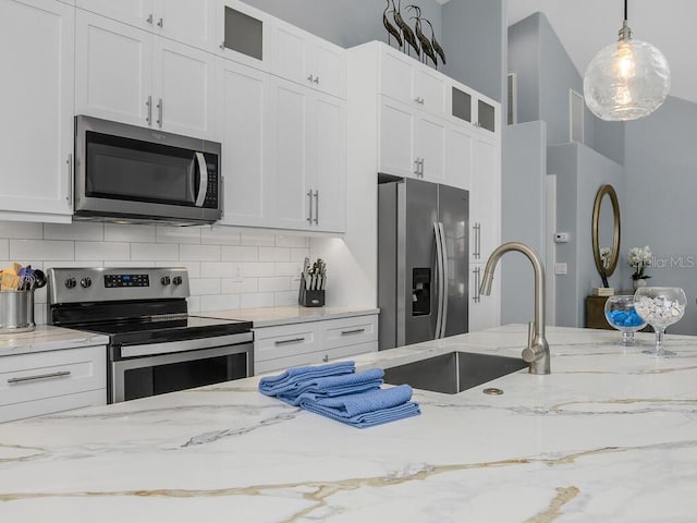 kitchen featuring white cabinets, glass insert cabinets, and stainless steel appliances