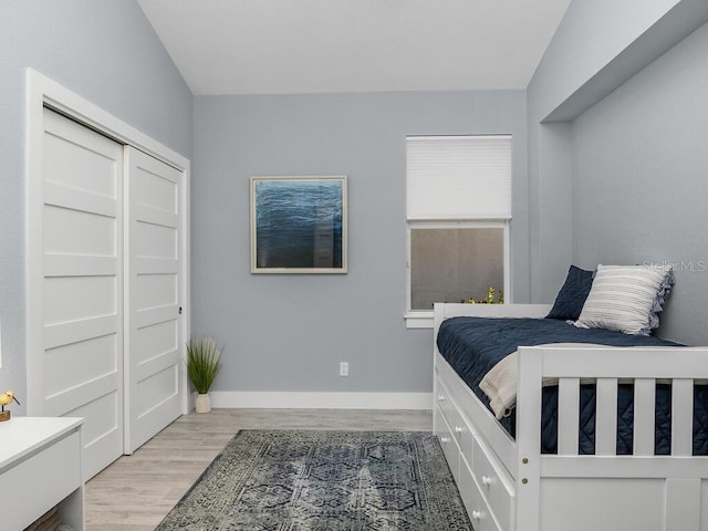 bedroom featuring light wood-type flooring and baseboards