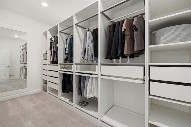 walk in closet featuring light carpet