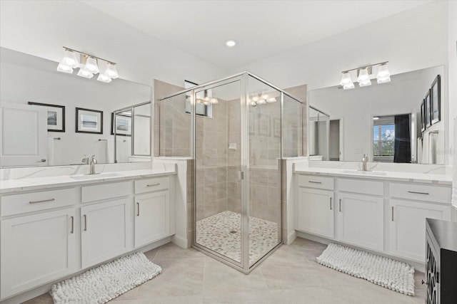 bathroom featuring tile patterned floors, vanity, and a shower with shower door