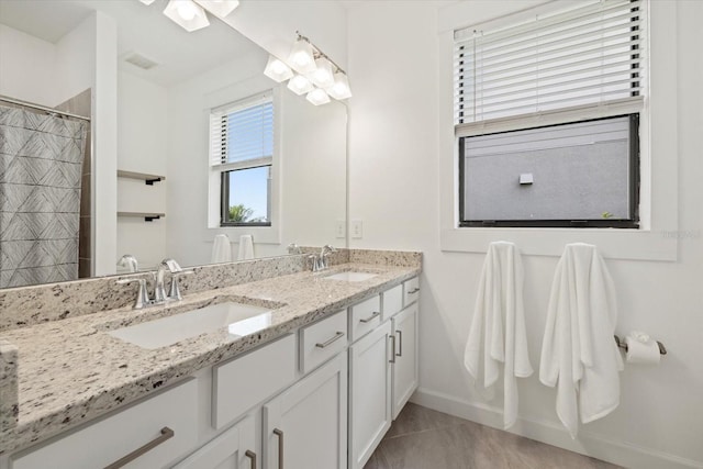 bathroom with tile patterned flooring, vanity, and curtained shower